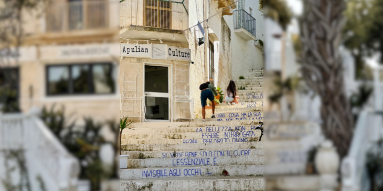 Popular coastal beach destination surrounded by dramatic limestone cliffs and white stone buildings, attracting travelers seeking social media worthy views.