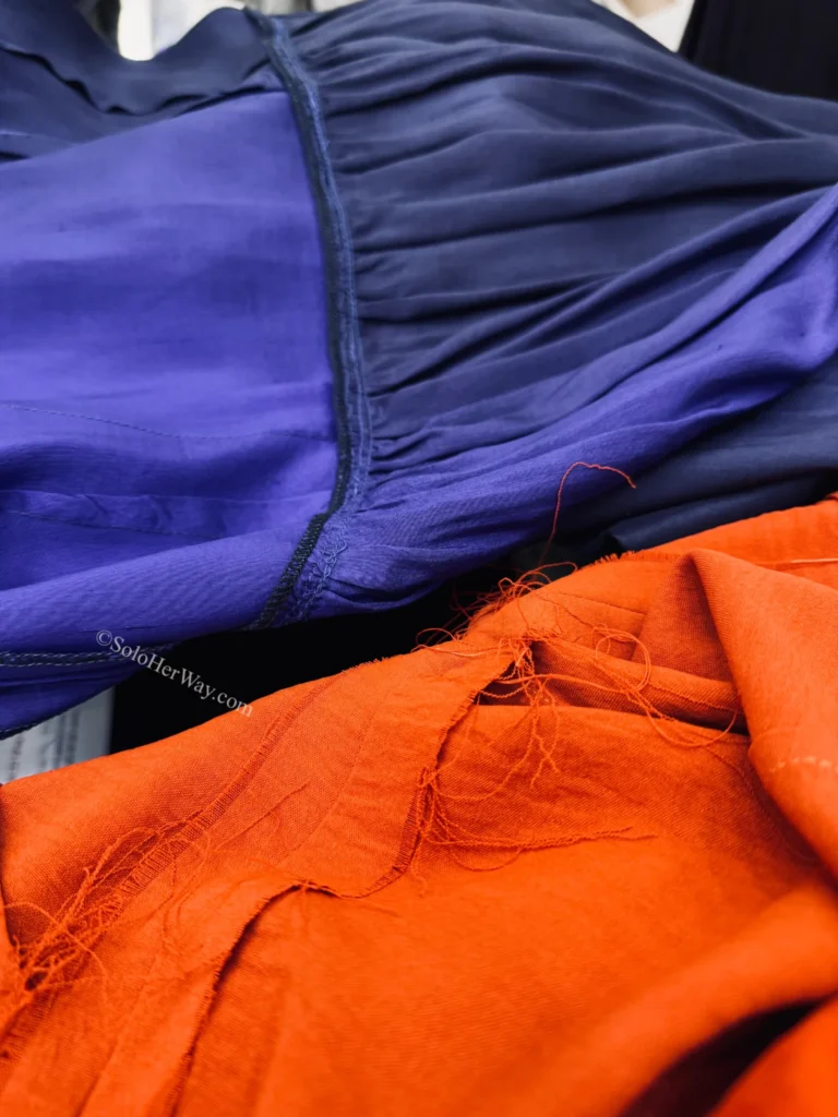 Getting Clothes Made in Hoi An & Ho Chi Minh City: What I Wish I’d Known 6 Close-up of garment fabrics showing stitching quality, loose threads, and material differences that can indicate fabric substitution or quality issues.