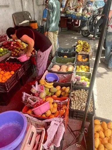 Ho Chi Minh City street fruit market with fresh mangoes, bananas, oranges, and local vendors showcasing everyday life in Vietnam.